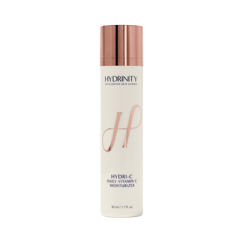 A pump bottle of Hydri-C Daily Vitamin C Moisturzer by hydrinity with a beige and rose gold color scheme.